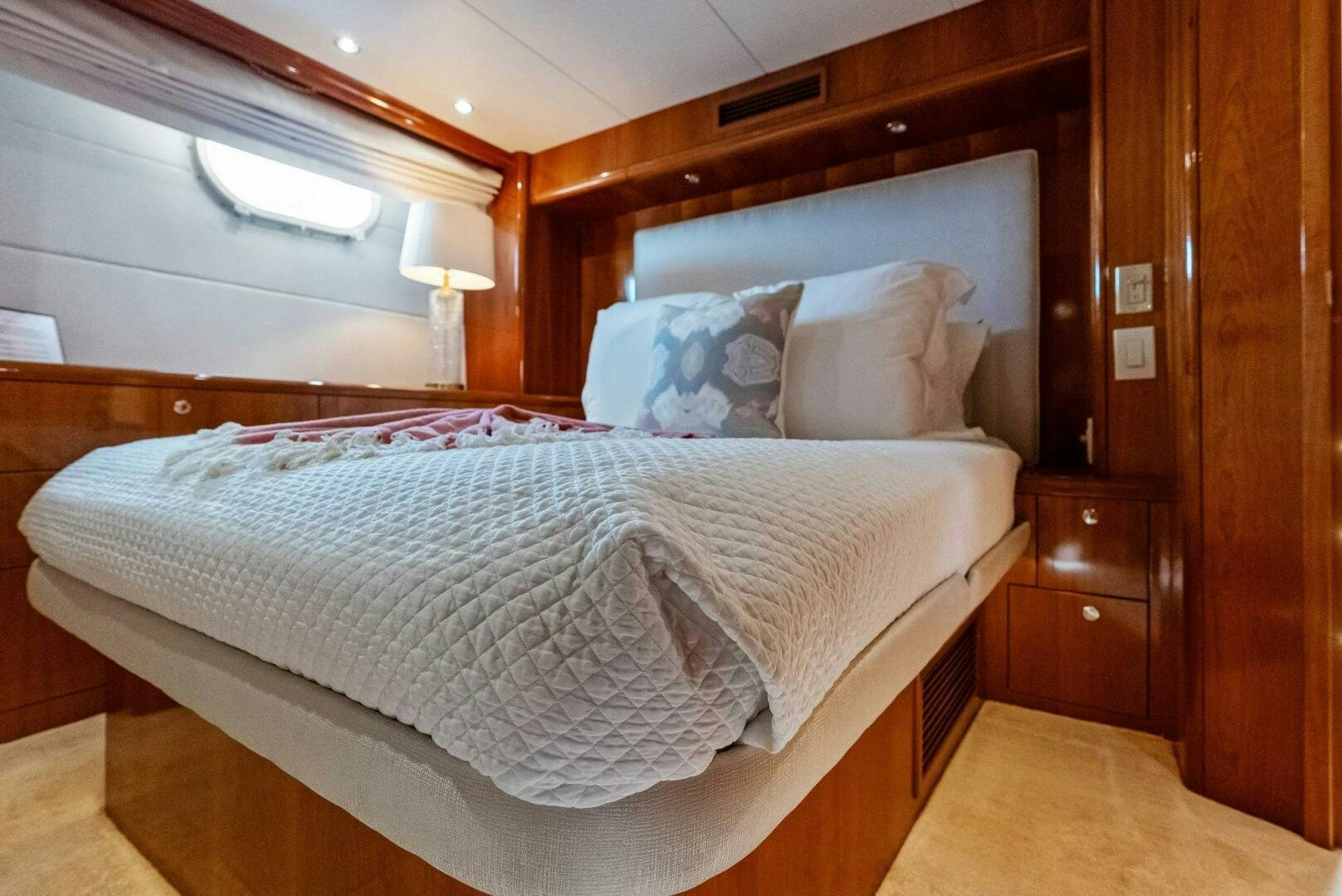 a bed with a white comforter aboard TOUCH N GO Yacht for Sale