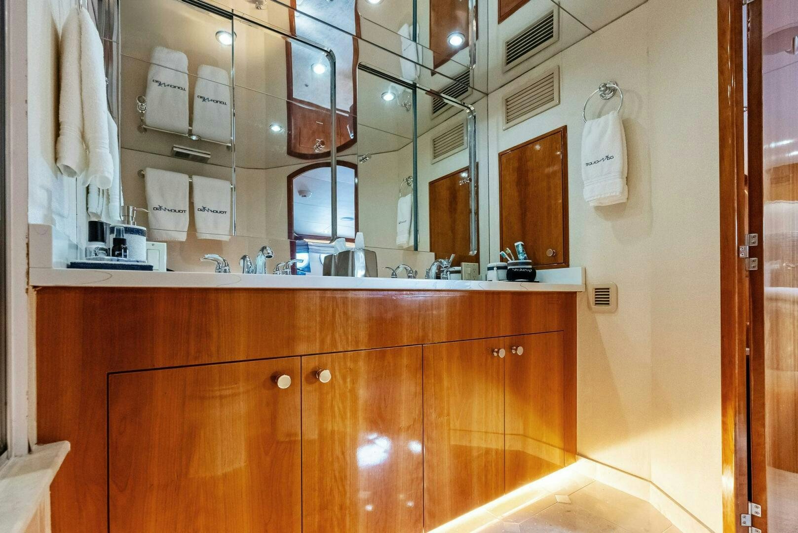 a bathroom with a mirror and a sink aboard TOUCH N GO Yacht for Sale