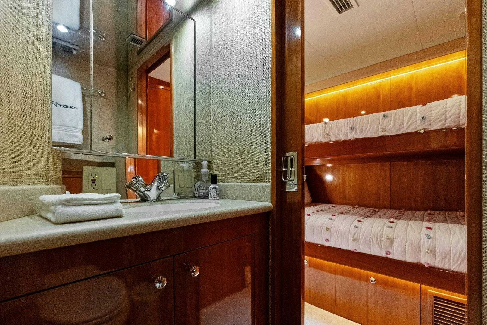 a bathroom with a sink and a mirror aboard TOUCH N GO Yacht for Sale