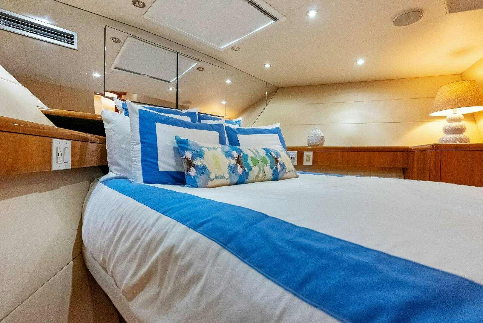 a bed with blue sheets aboard TOUCH N GO Yacht for Sale