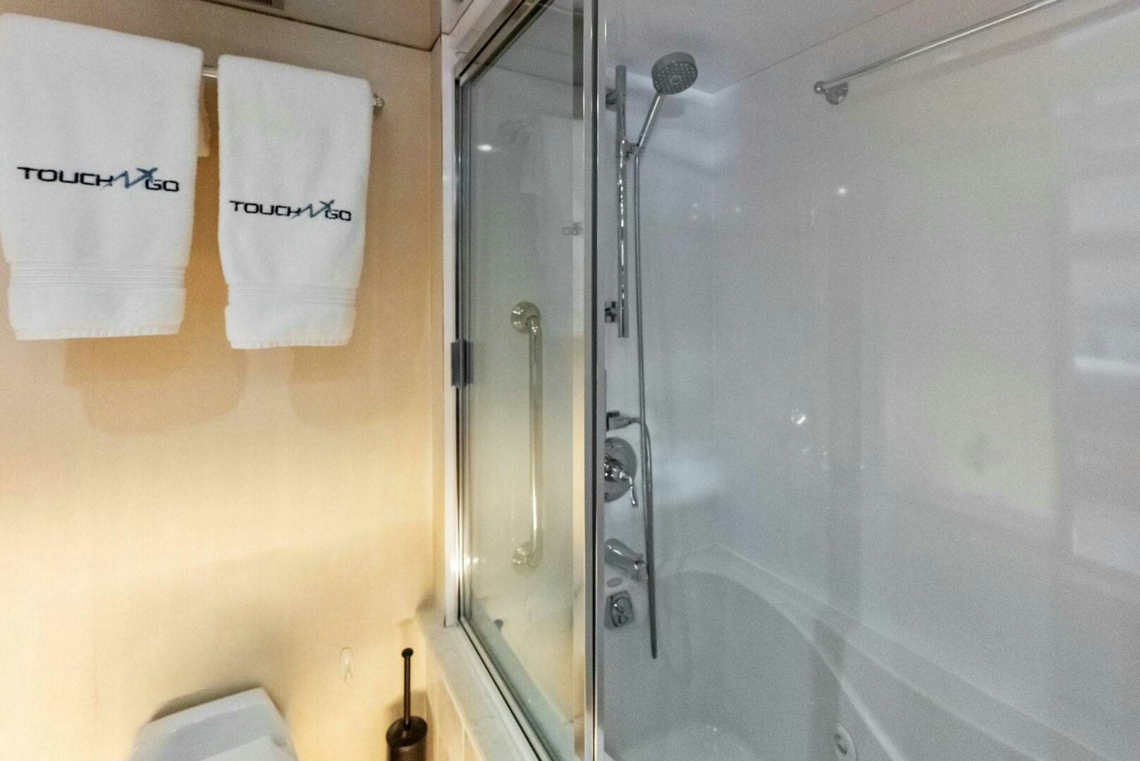 a bathroom with a shower and a sink aboard TOUCH N GO Yacht for Sale