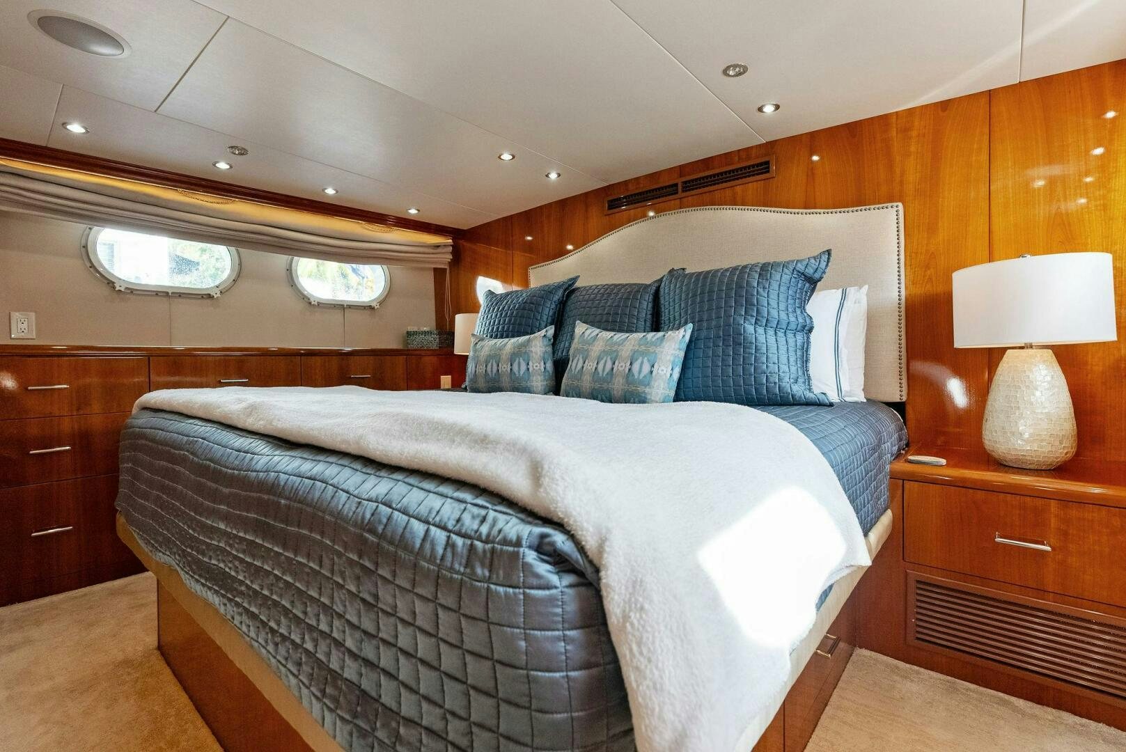 a bed with a blue comforter aboard TOUCH N GO Yacht for Sale