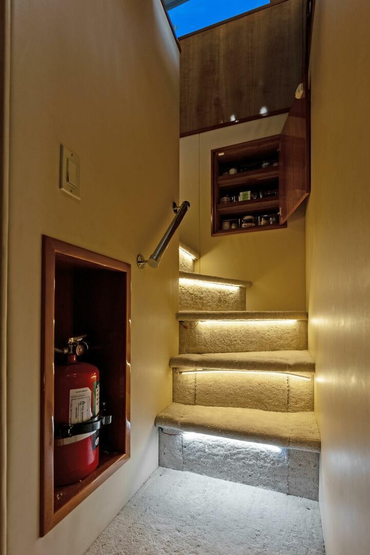 a staircase with a red light aboard TOUCH N GO Yacht for Sale