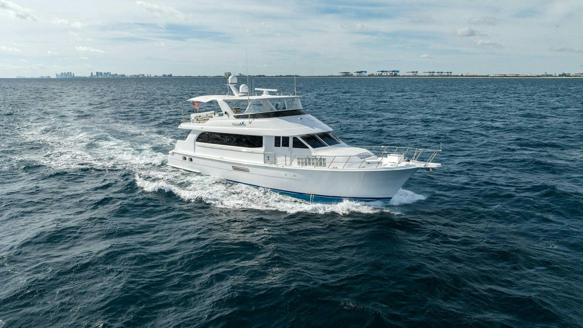 a white boat on the water aboard TOUCH N GO Yacht for Sale