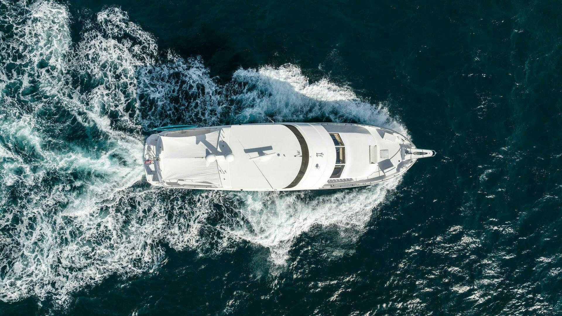 a car driving on a wave aboard TOUCH N GO Yacht for Sale