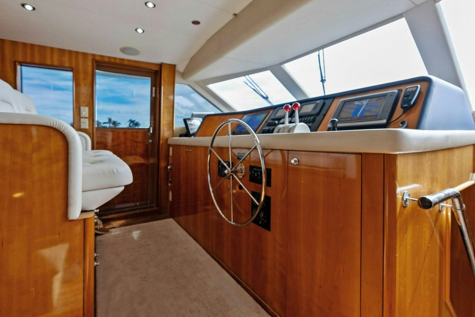 a room with a wood cabinet and a large window aboard TOUCH N GO Yacht for Sale