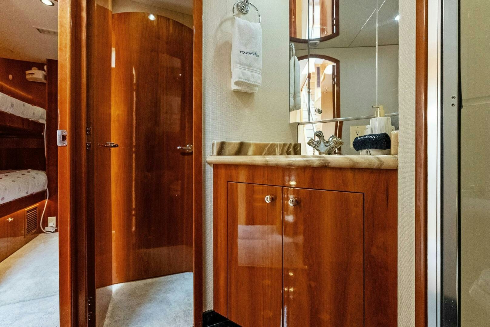 a bathroom with a wood cabinet aboard TOUCH N GO Yacht for Sale