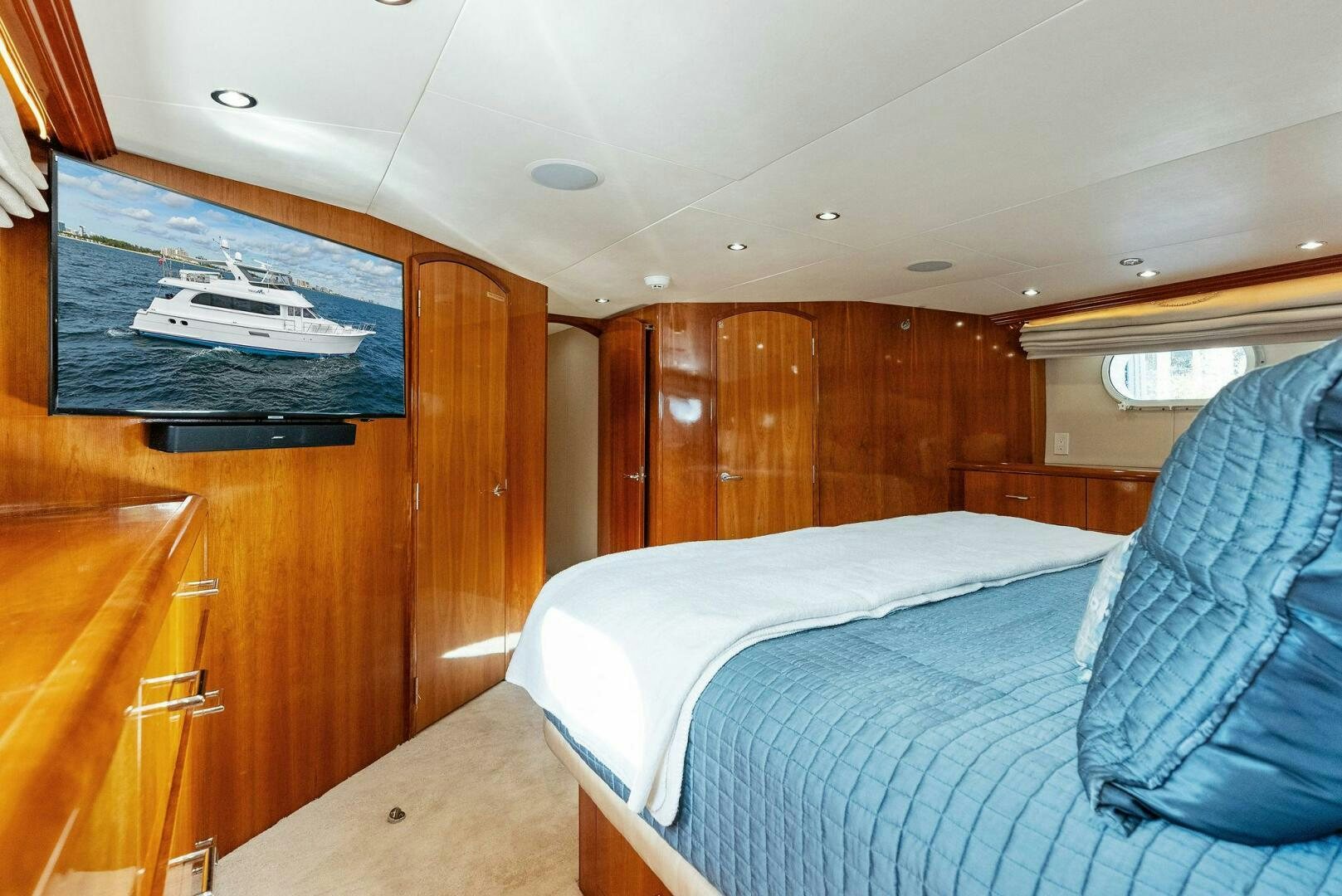 a bedroom with a bed and a desk aboard TOUCH N GO Yacht for Sale