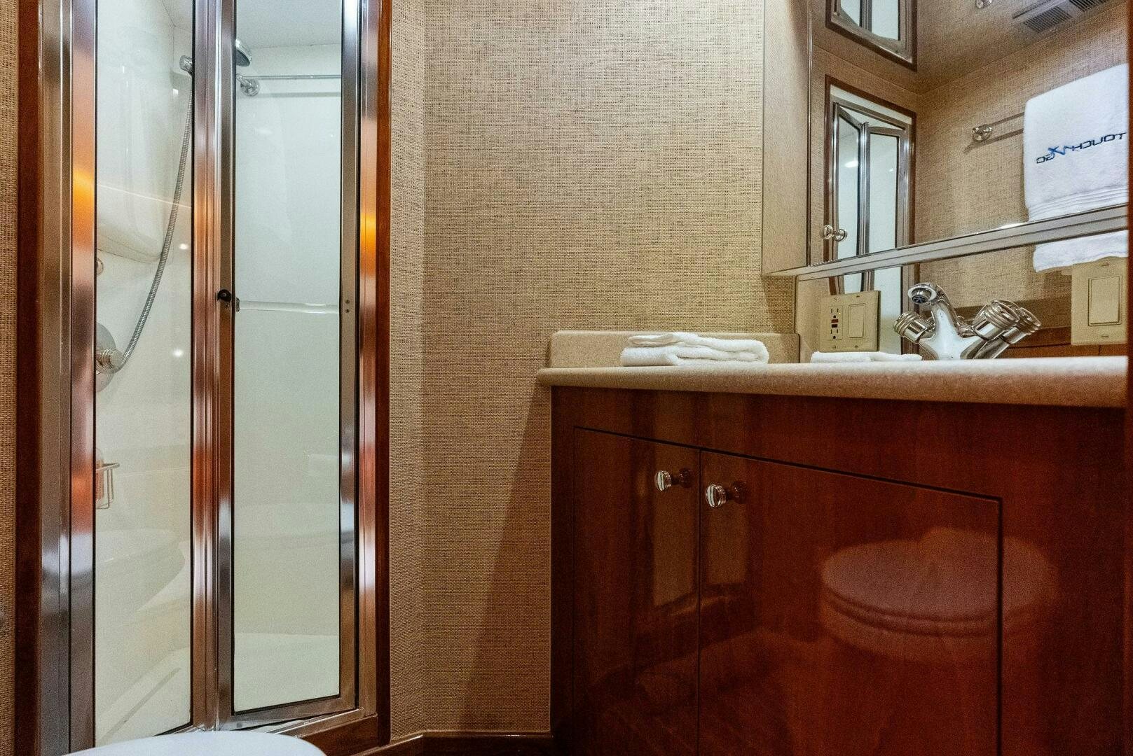 a bathroom with a sink and a mirror aboard TOUCH N GO Yacht for Sale