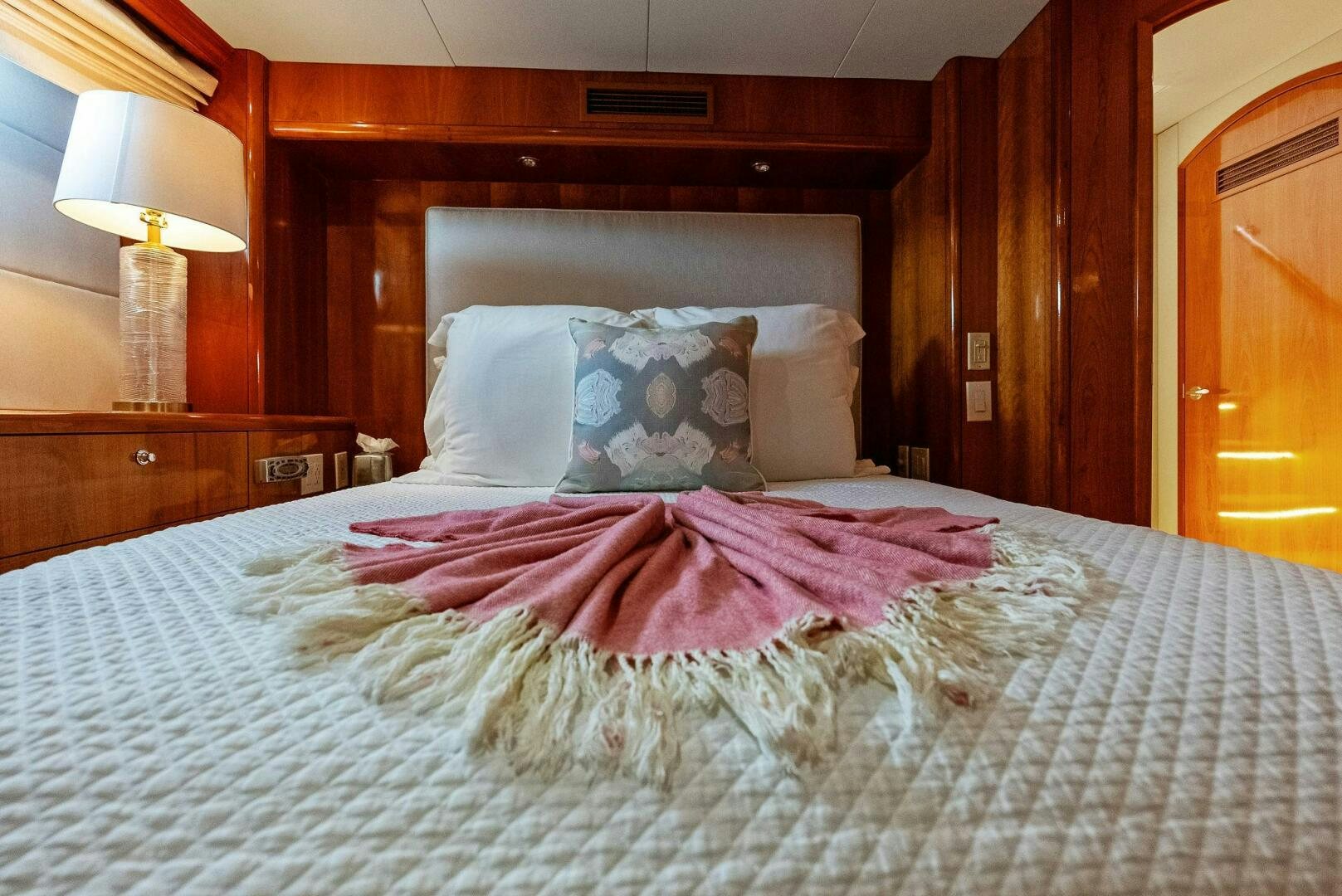 a bed with a pink blanket aboard TOUCH N GO Yacht for Sale