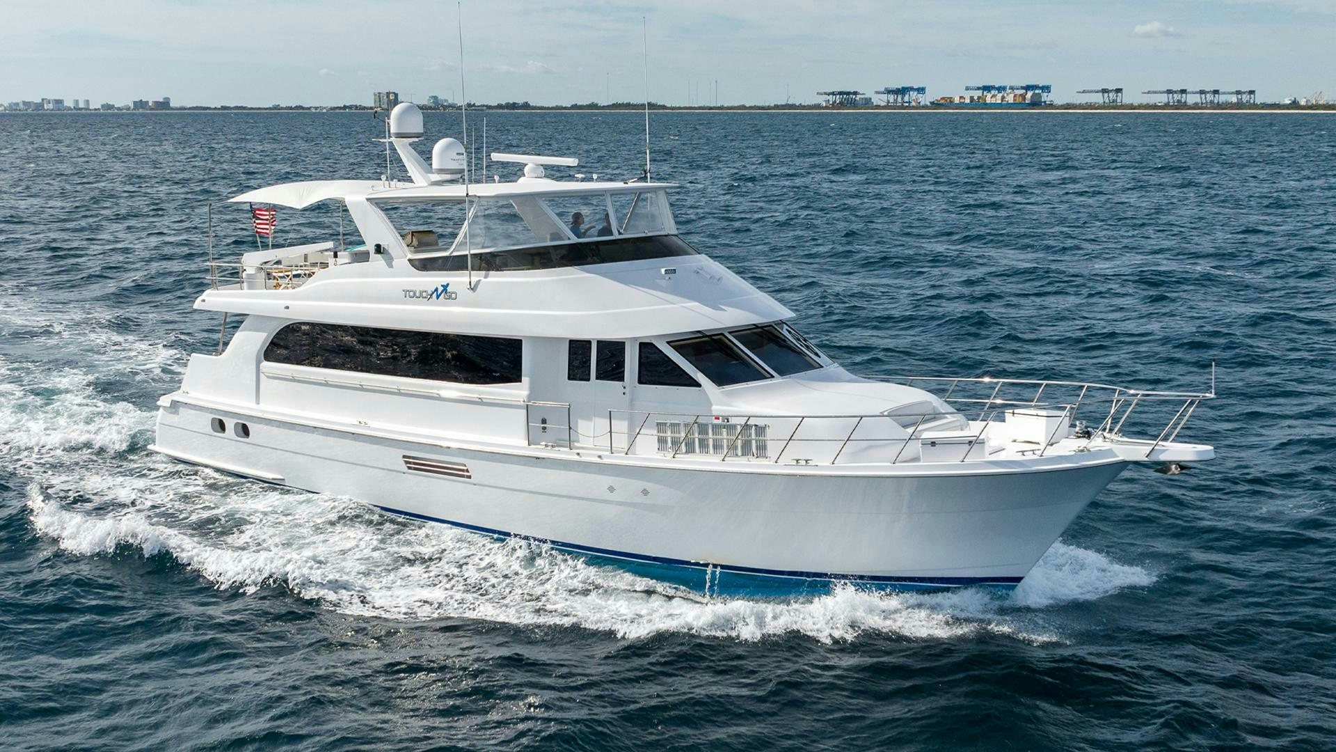 a white yacht on the water aboard TOUCH N GO Yacht for Sale