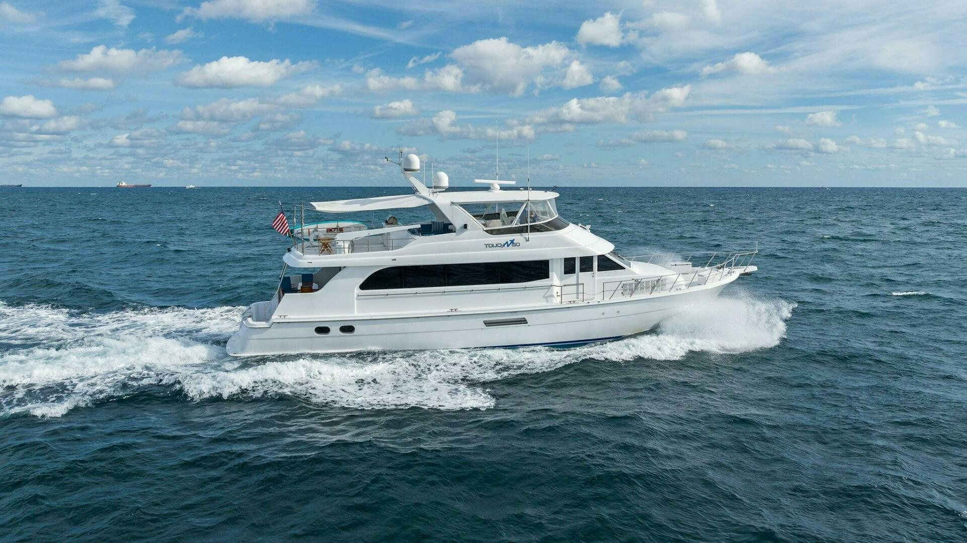 a white boat on the water aboard TOUCH N GO Yacht for Sale