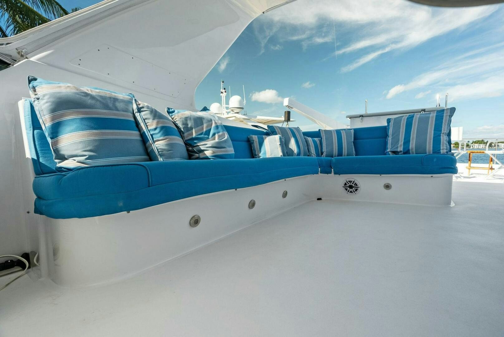 a white boat with blue seats aboard TOUCH N GO Yacht for Sale