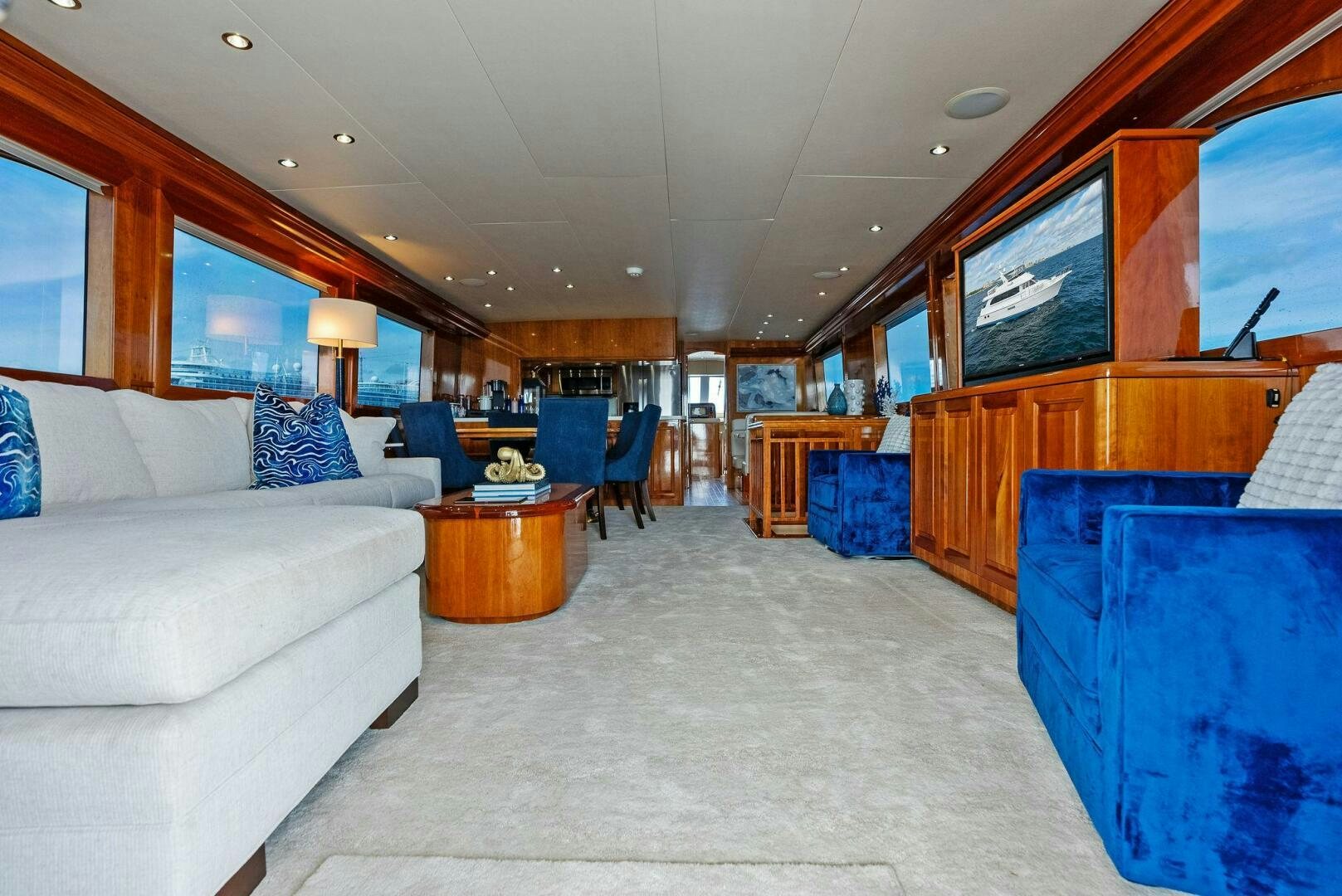 a living room with a large screen aboard TOUCH N GO Yacht for Sale