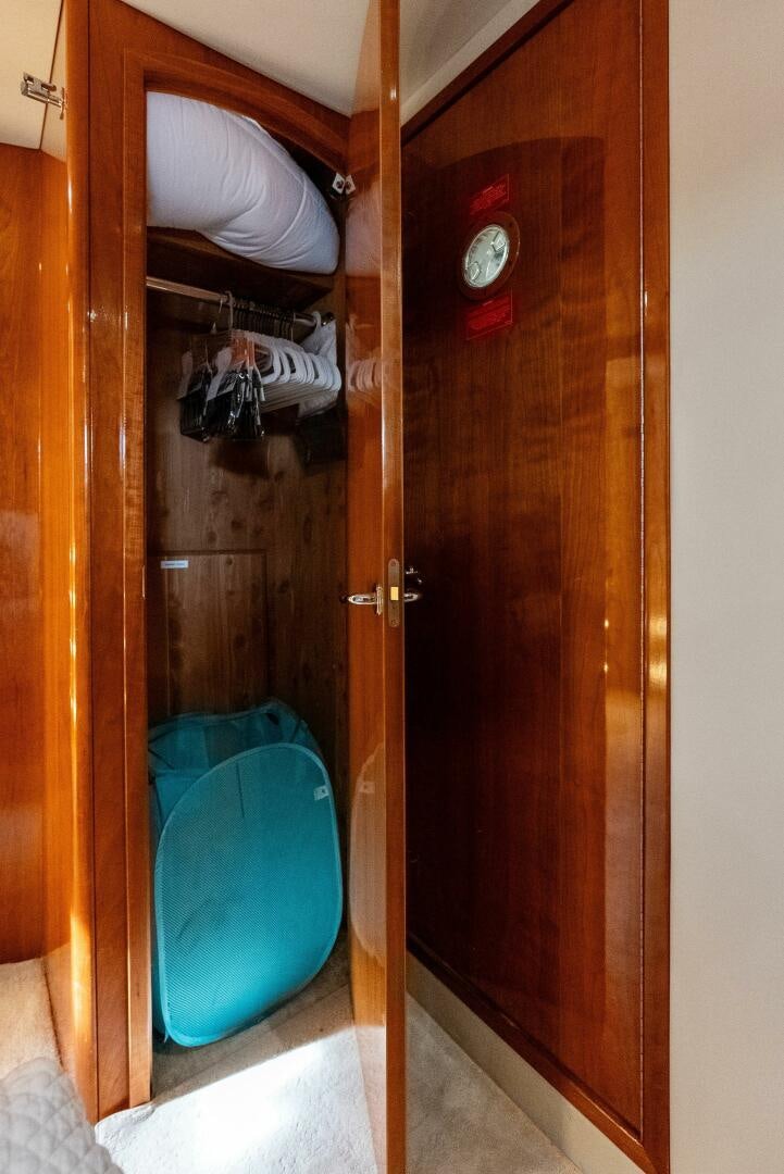 a closet with a blue bin aboard TOUCH N GO Yacht for Sale