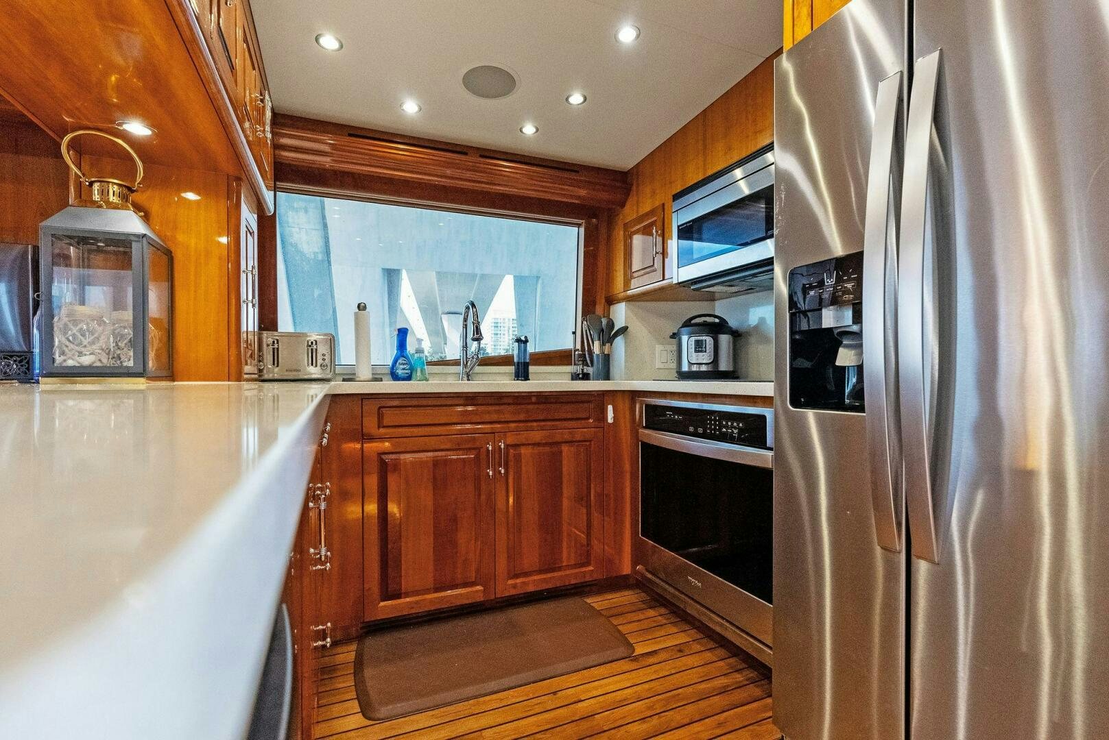 a kitchen with a stainless steel refrigerator aboard TOUCH N GO Yacht for Sale