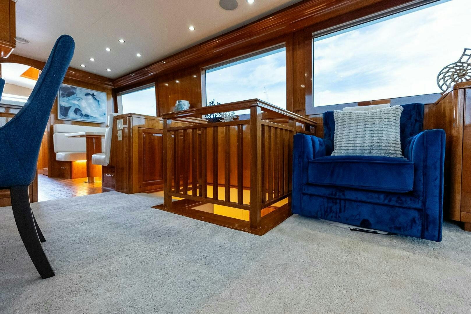 a blue couch and a blue chair in a room with wood walls aboard TOUCH N GO Yacht for Sale