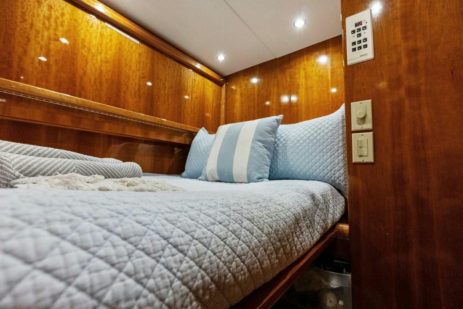 a bed with a white comforter aboard TOUCH N GO Yacht for Sale