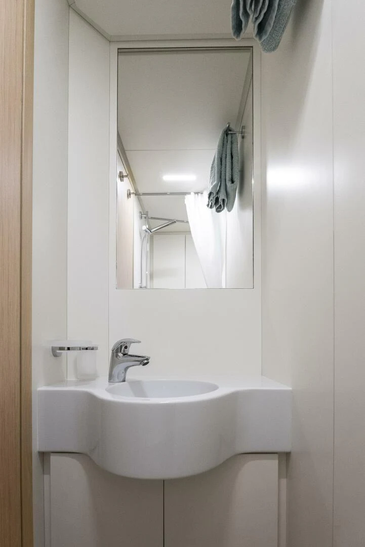 a bathroom with a sink and mirror aboard PINCH ME Yacht for Sale