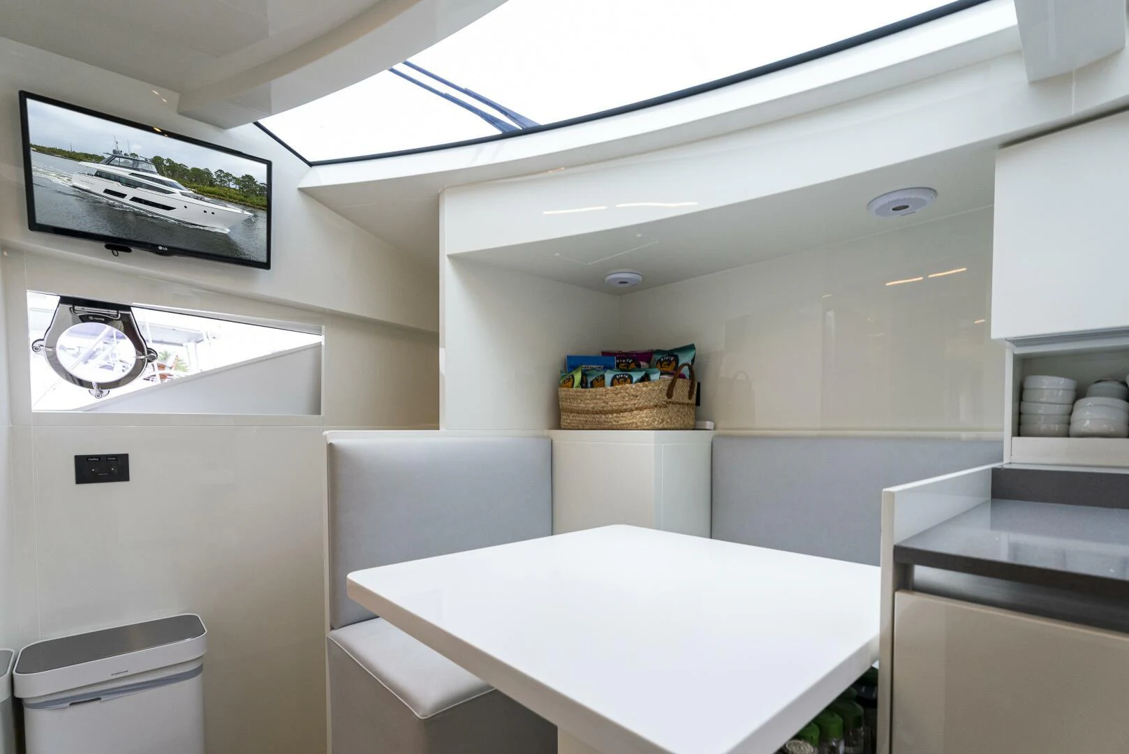 a white room with a table and chairs aboard PINCH ME Yacht for Sale