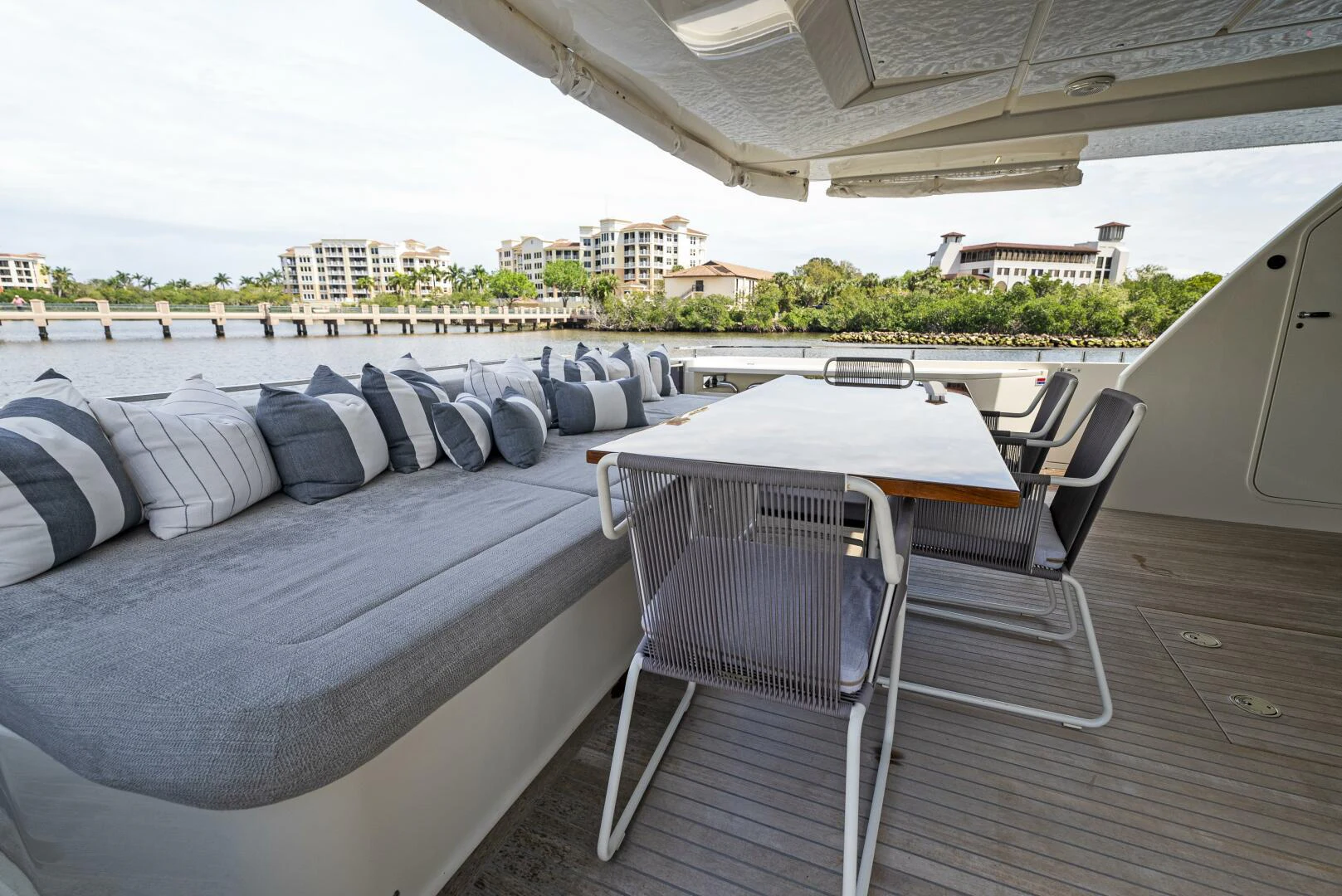 a deck with chairs and a table on it aboard PINCH ME Yacht for Sale