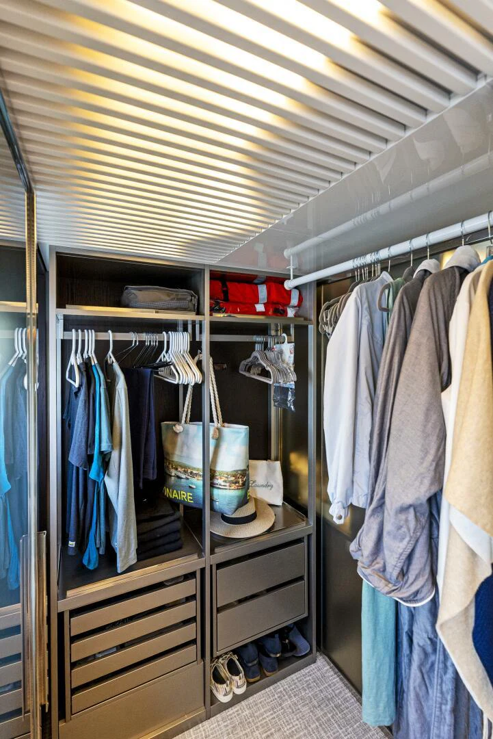 a closet with clothes aboard PINCH ME Yacht for Sale