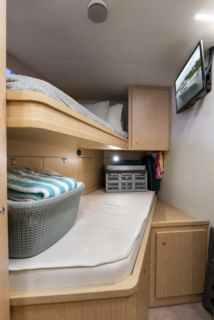 a bed with a television on top of it aboard PINCH ME Yacht for Sale