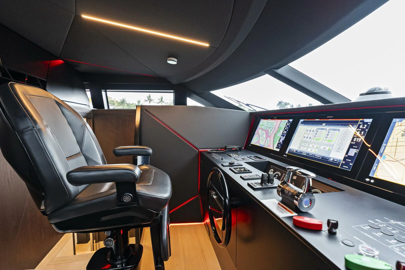 a chair in front of a desk with multiple monitors aboard PINCH ME Yacht for Sale