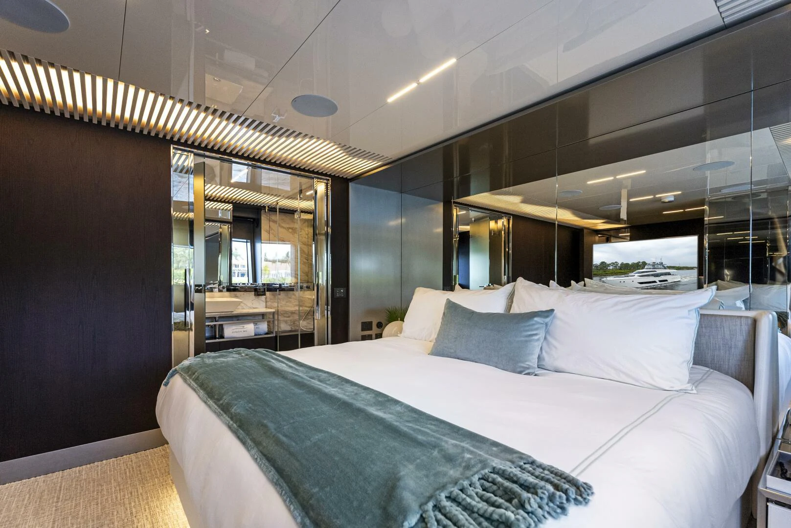 a bed with a blue sheet aboard PINCH ME Yacht for Sale