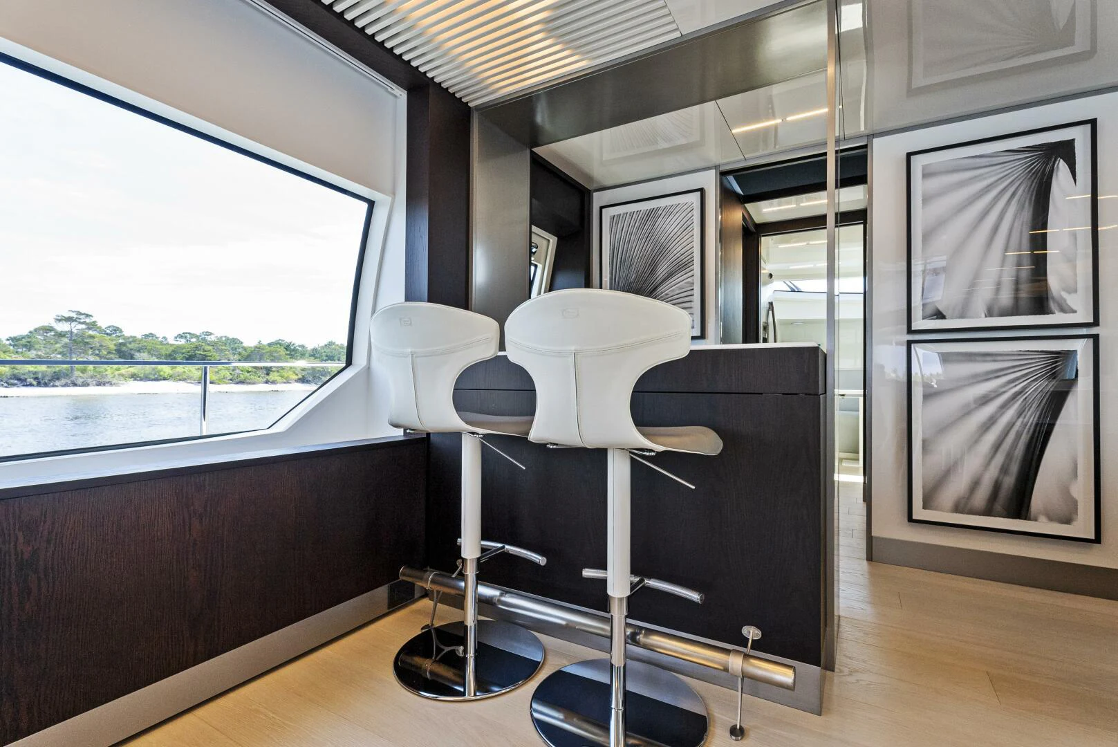 a room with a large window and a table with chairs aboard PINCH ME Yacht for Sale
