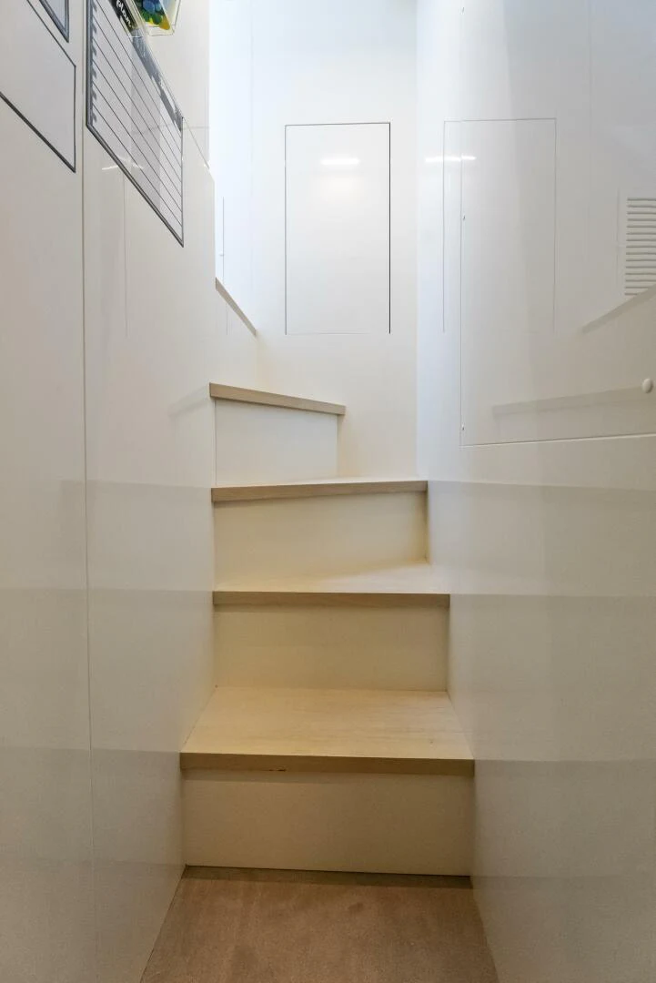 a white staircase with a white wall aboard PINCH ME Yacht for Sale