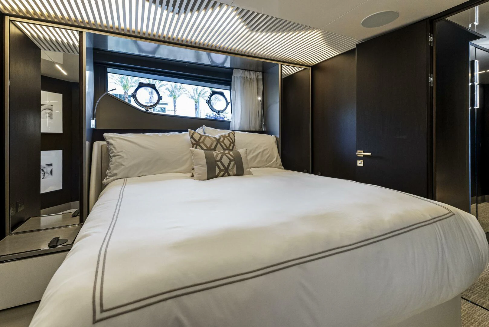 a bed with a white sheet and pillows aboard PINCH ME Yacht for Sale