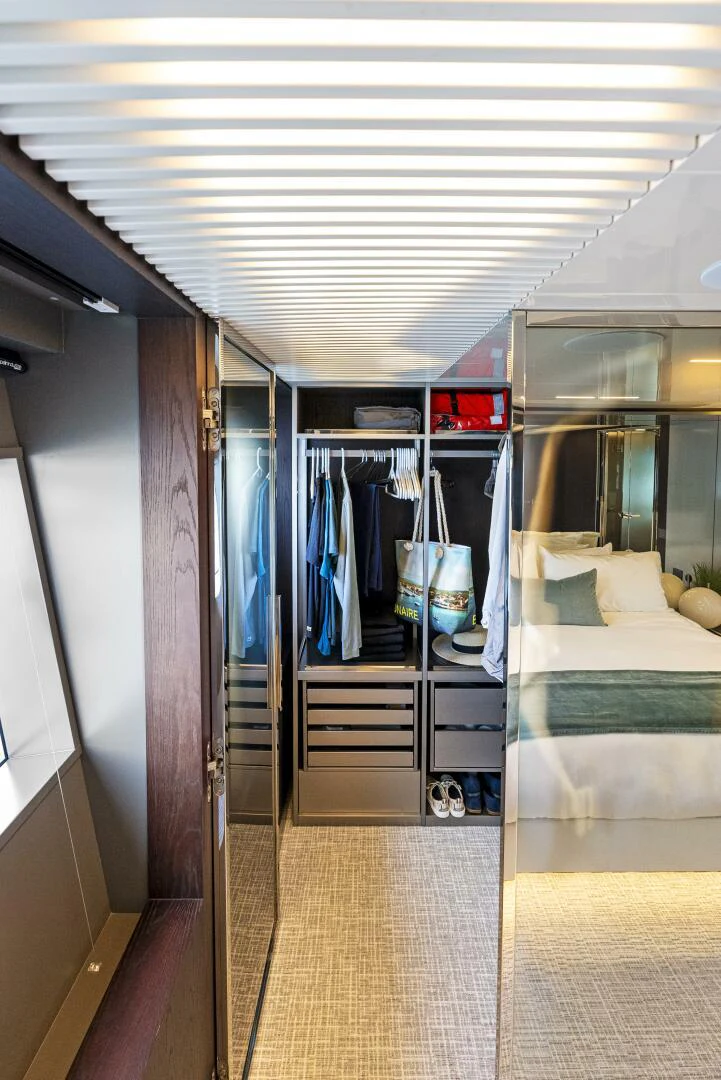 a room with a bed and a closet aboard PINCH ME Yacht for Sale