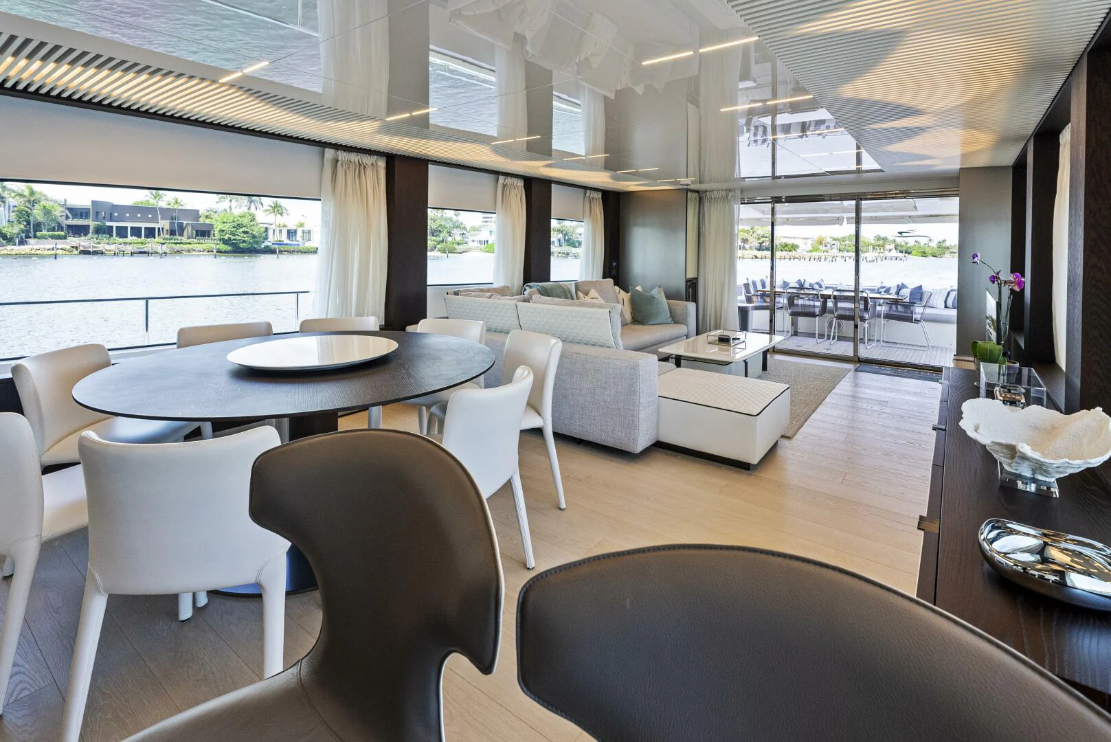 a room with a table chairs and a large window aboard PINCH ME Yacht for Sale