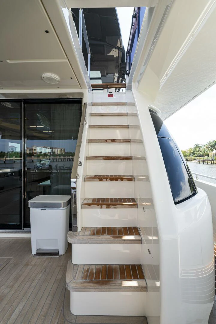 a white staircase in a building aboard PINCH ME Yacht for Sale