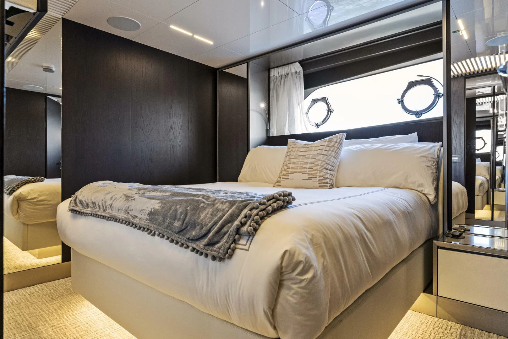 a bed with a white comforter aboard PINCH ME Yacht for Sale