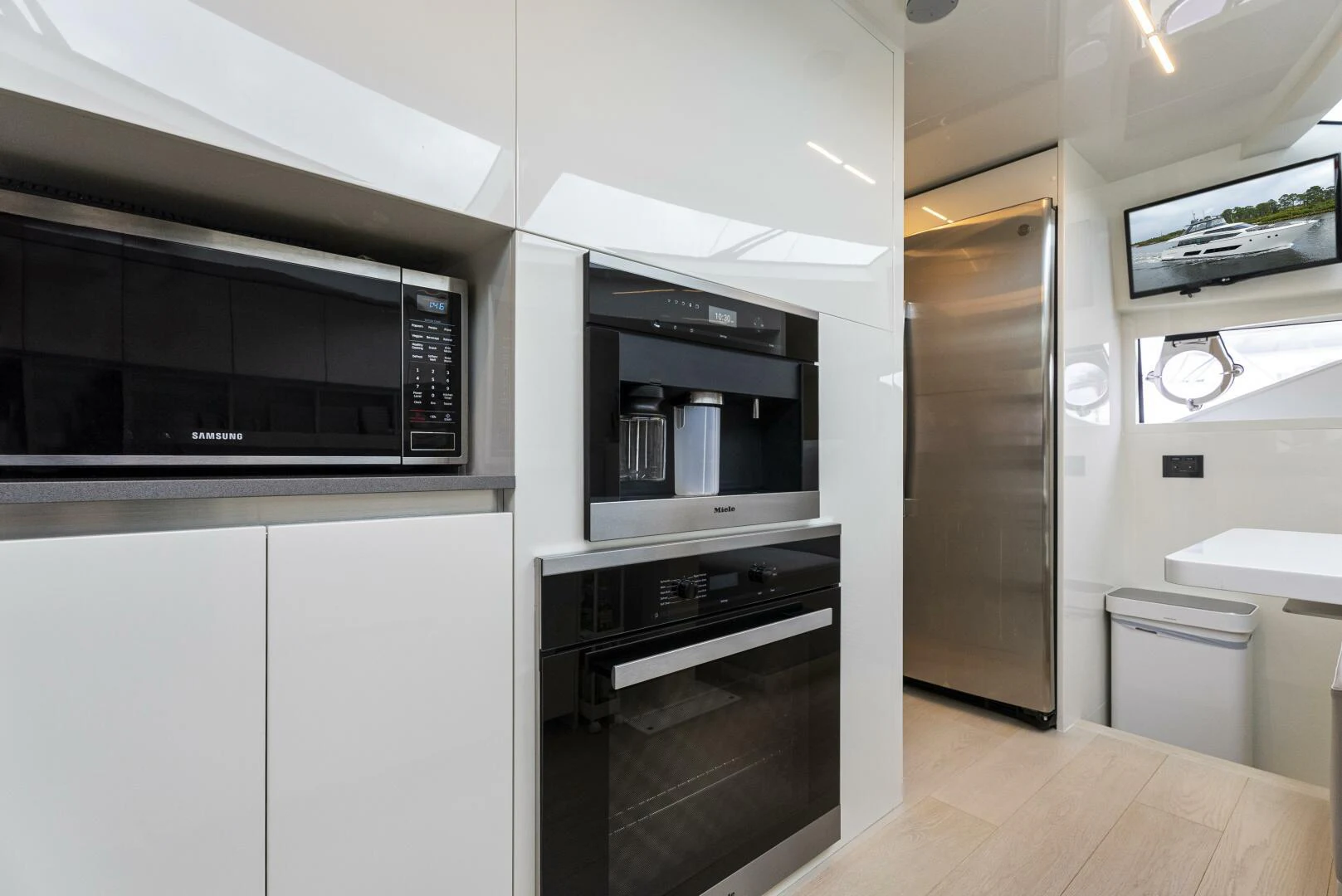 a kitchen with white cabinets aboard PINCH ME Yacht for Sale