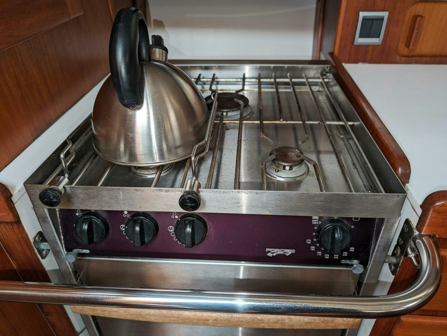 a stove with a kettle on it aboard MOJO Yacht for Sale