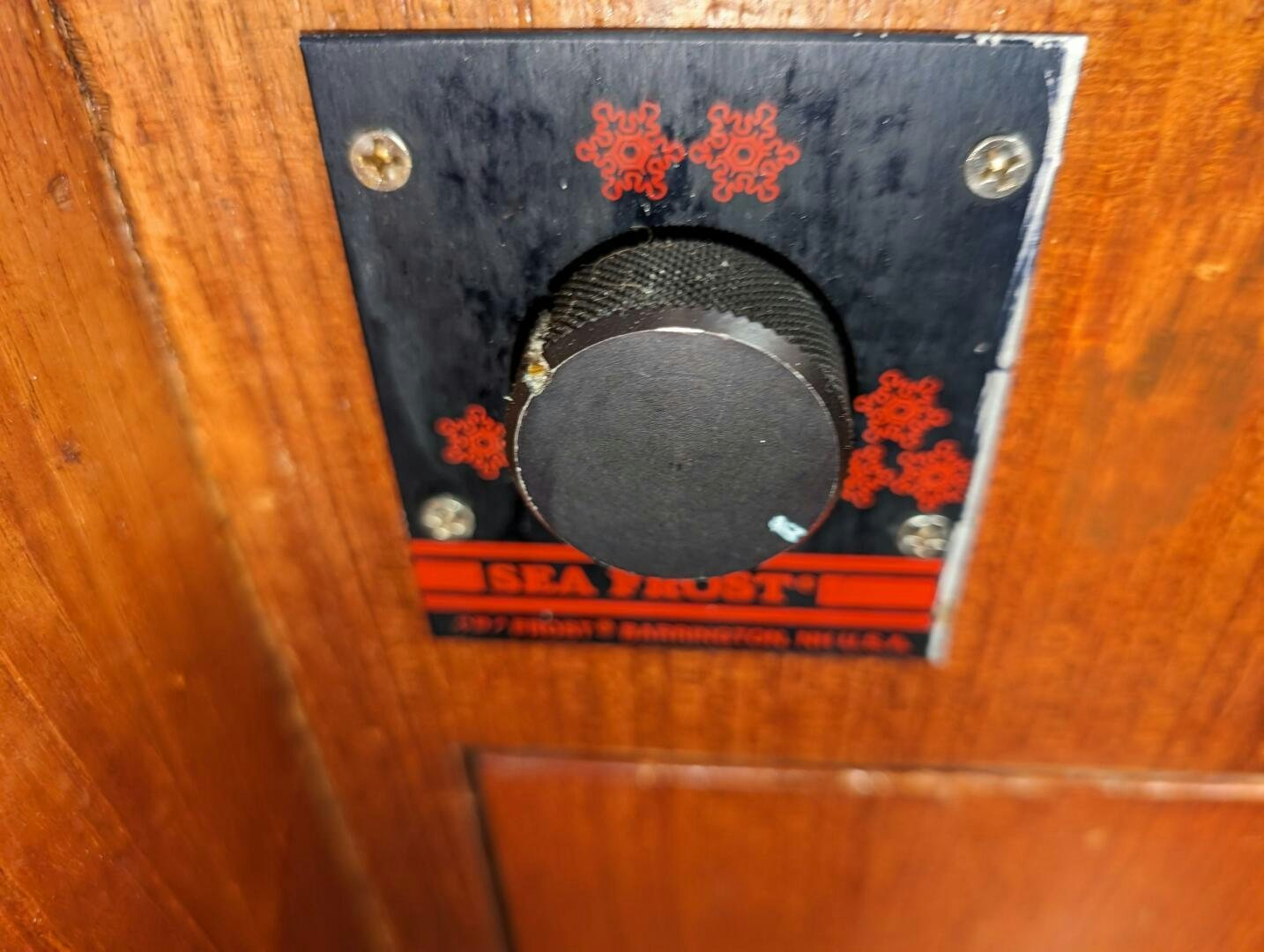 a black and white rectangular object on a wooden surface aboard MOJO Yacht for Sale