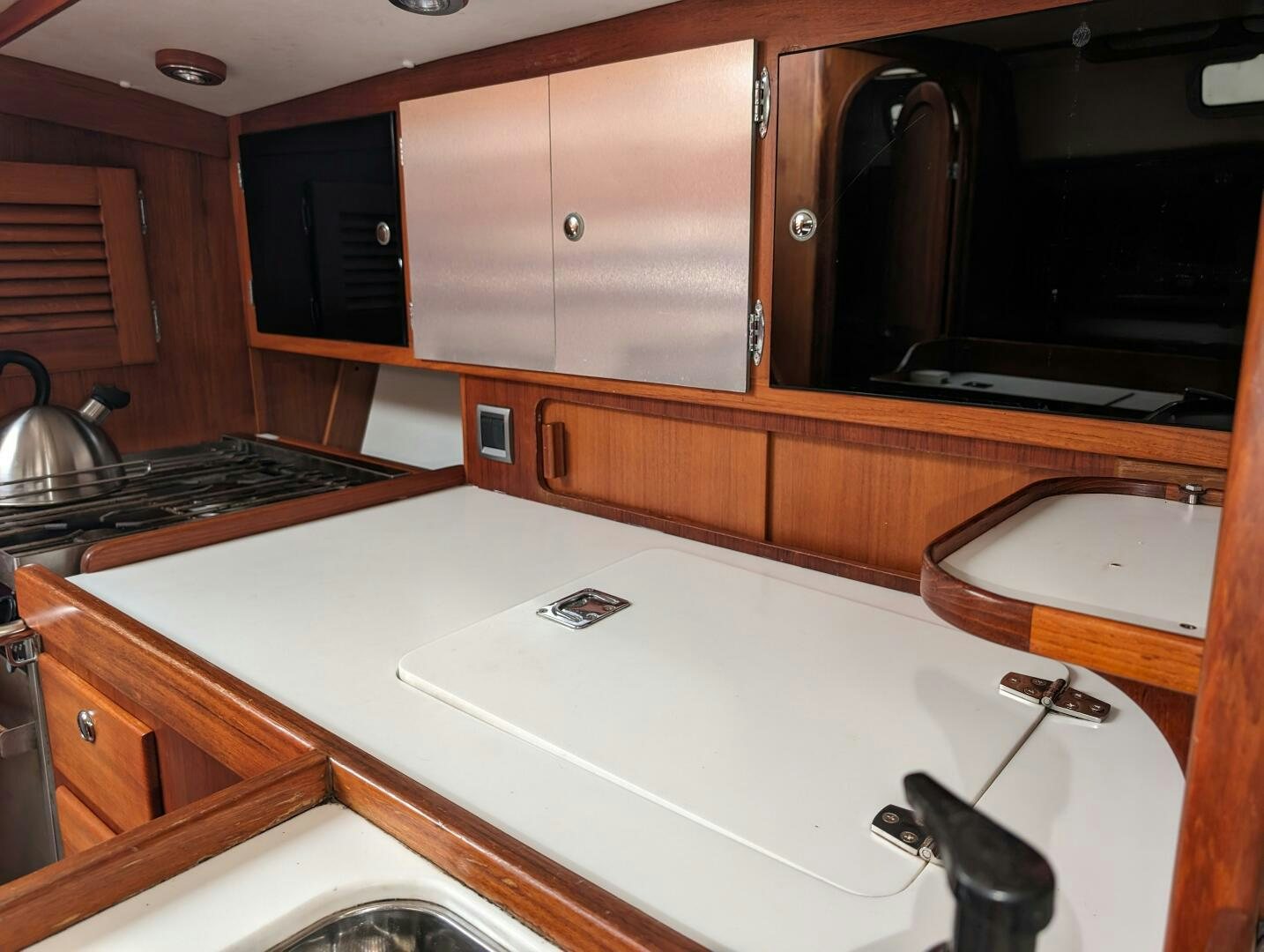 a kitchen with a sink and a stove aboard MOJO Yacht for Sale