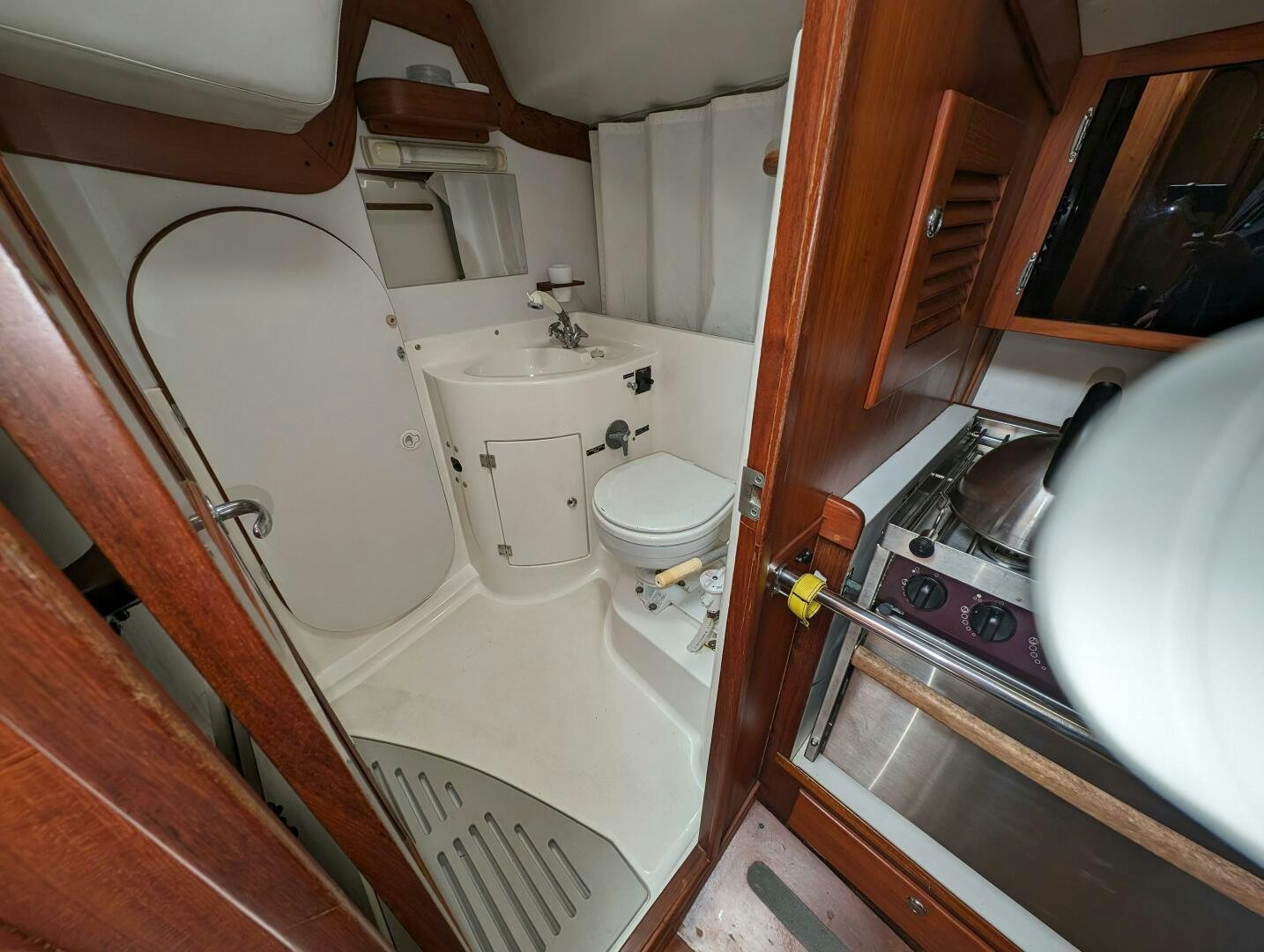 a small bathroom with a sink and toilet aboard MOJO Yacht for Sale