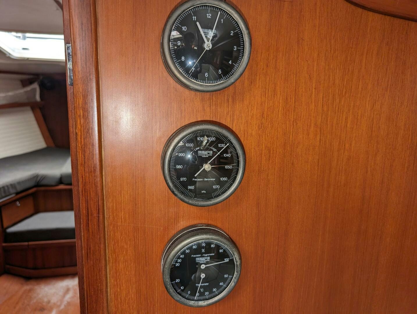 a couple of clocks on a wood table aboard MOJO Yacht for Sale