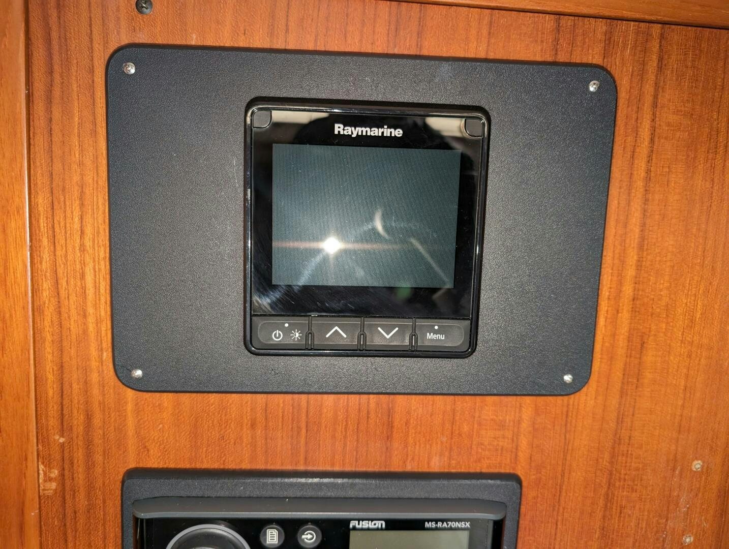a black television on a wooden surface aboard MOJO Yacht for Sale