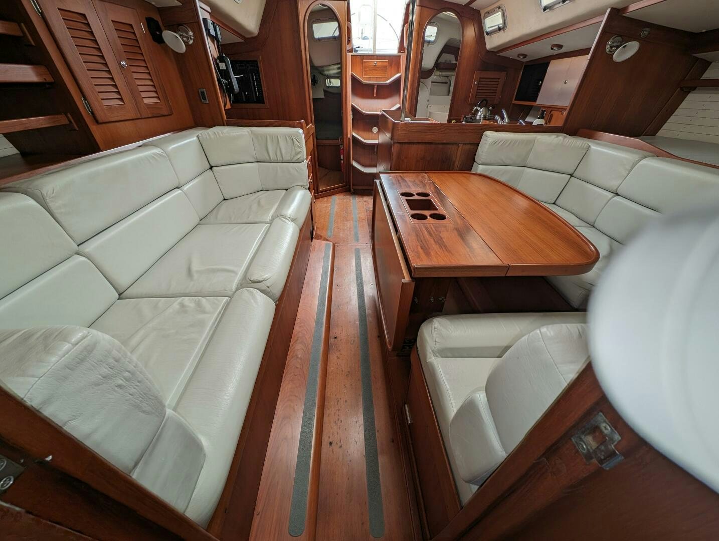 a living room with a couch and a table aboard MOJO Yacht for Sale