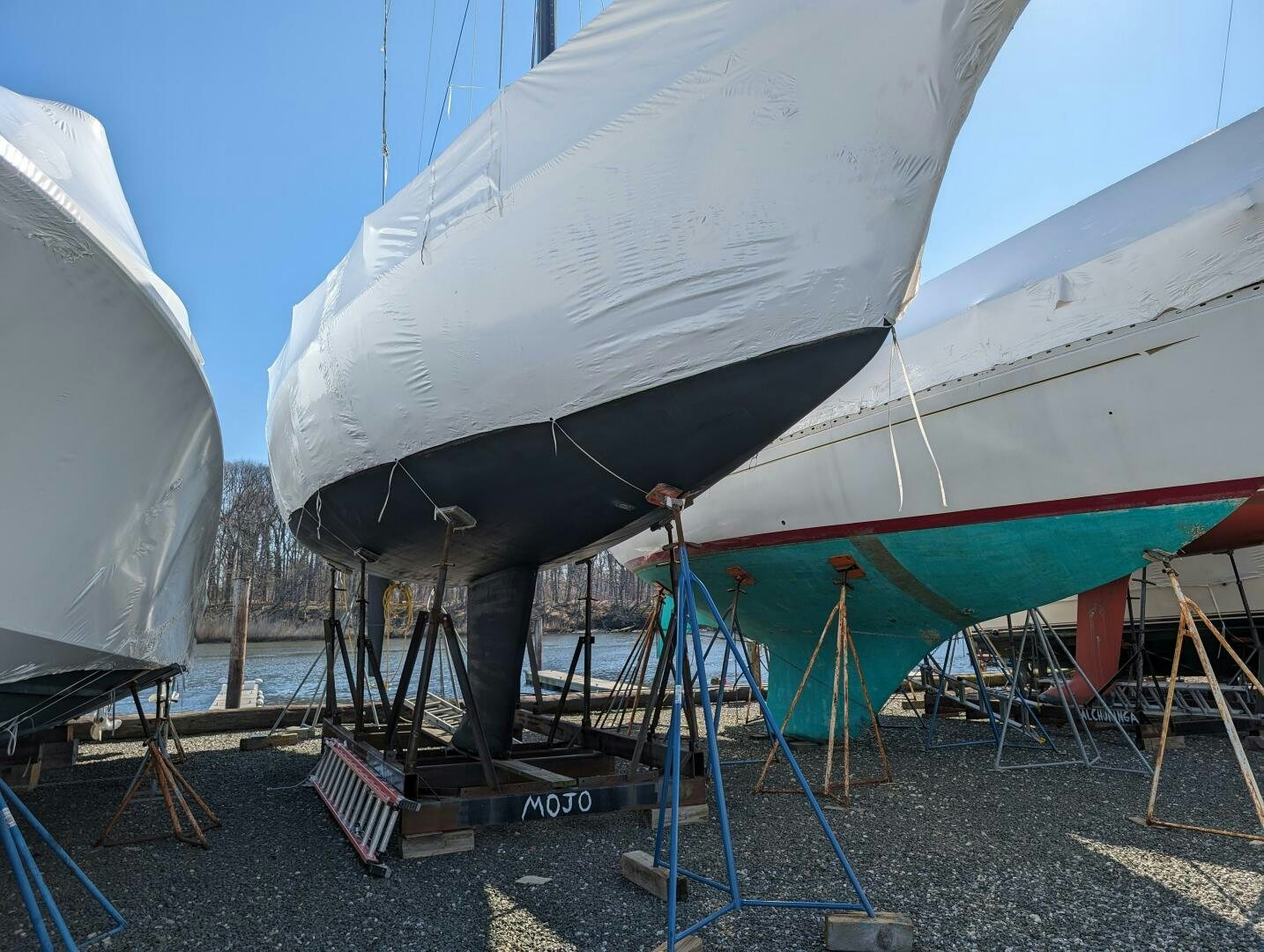 a person standing next to a large white satellite dish aboard MOJO Yacht for Sale