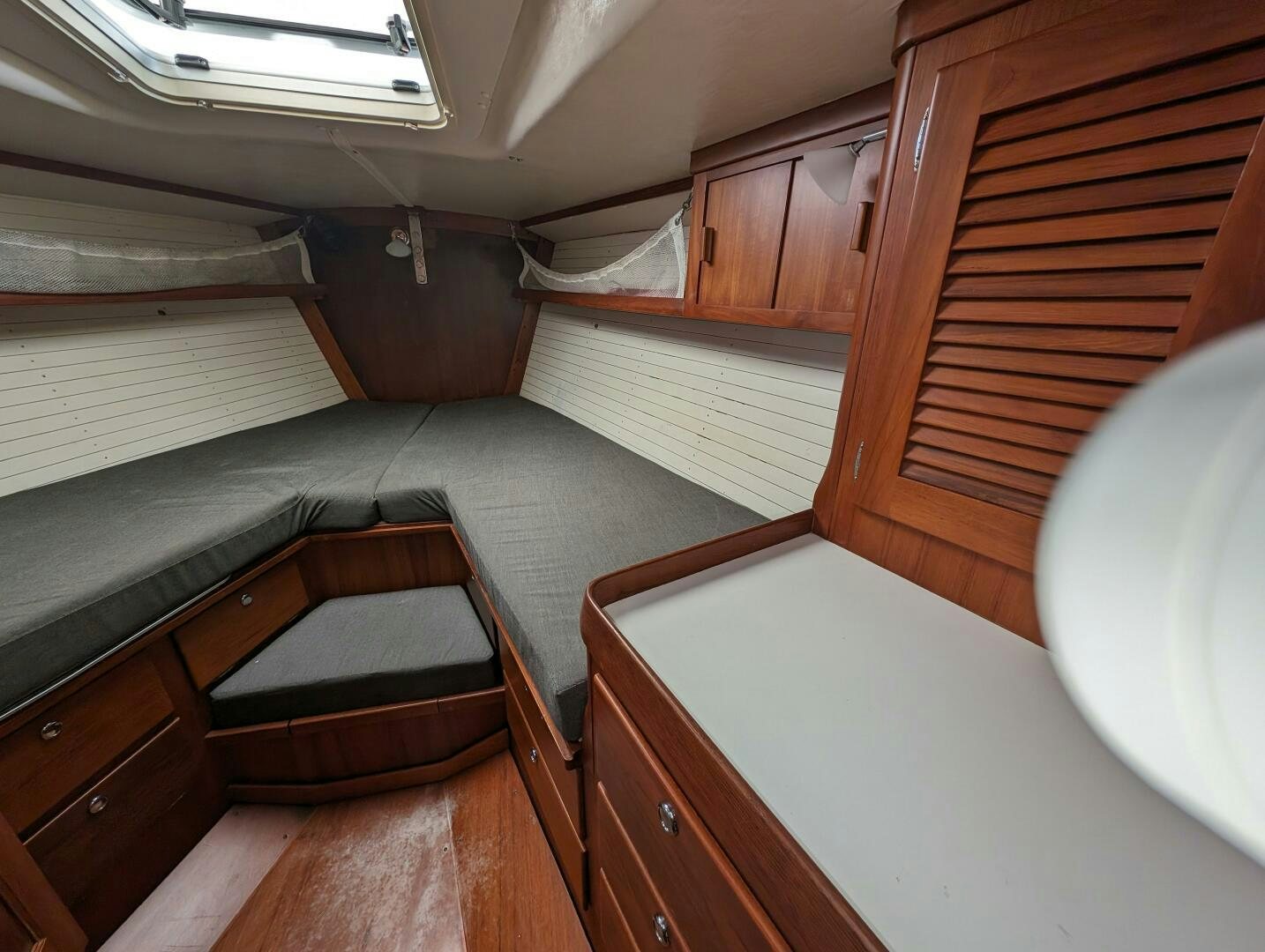 a room with a bed and a window aboard MOJO Yacht for Sale