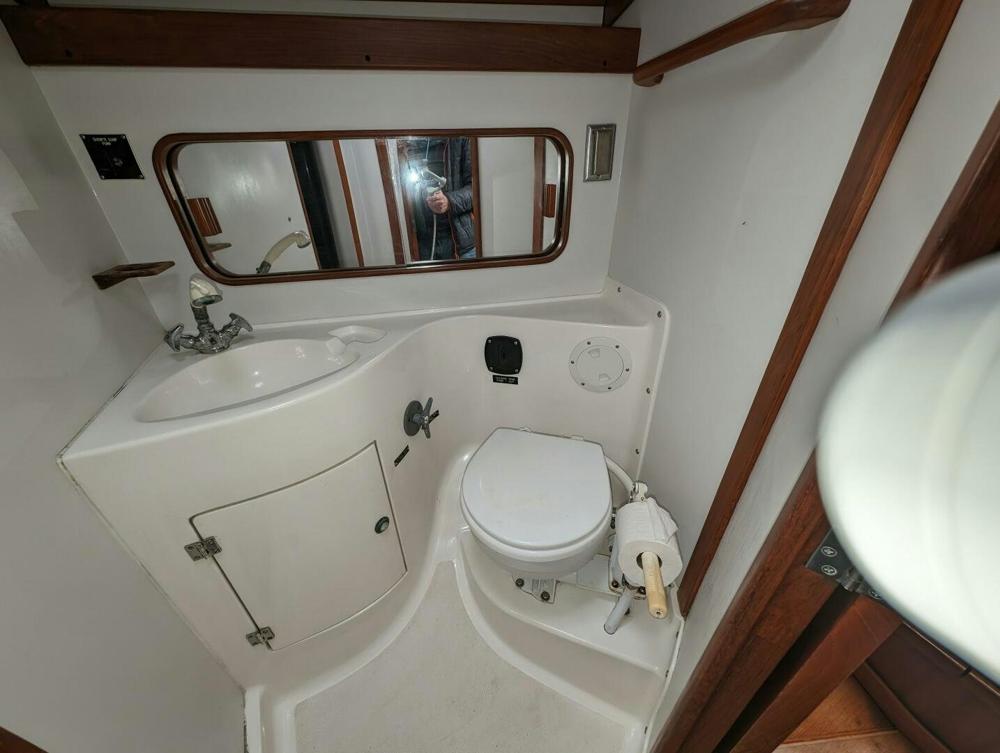 a bathroom with a toilet sink and a mirror aboard MOJO Yacht for Sale