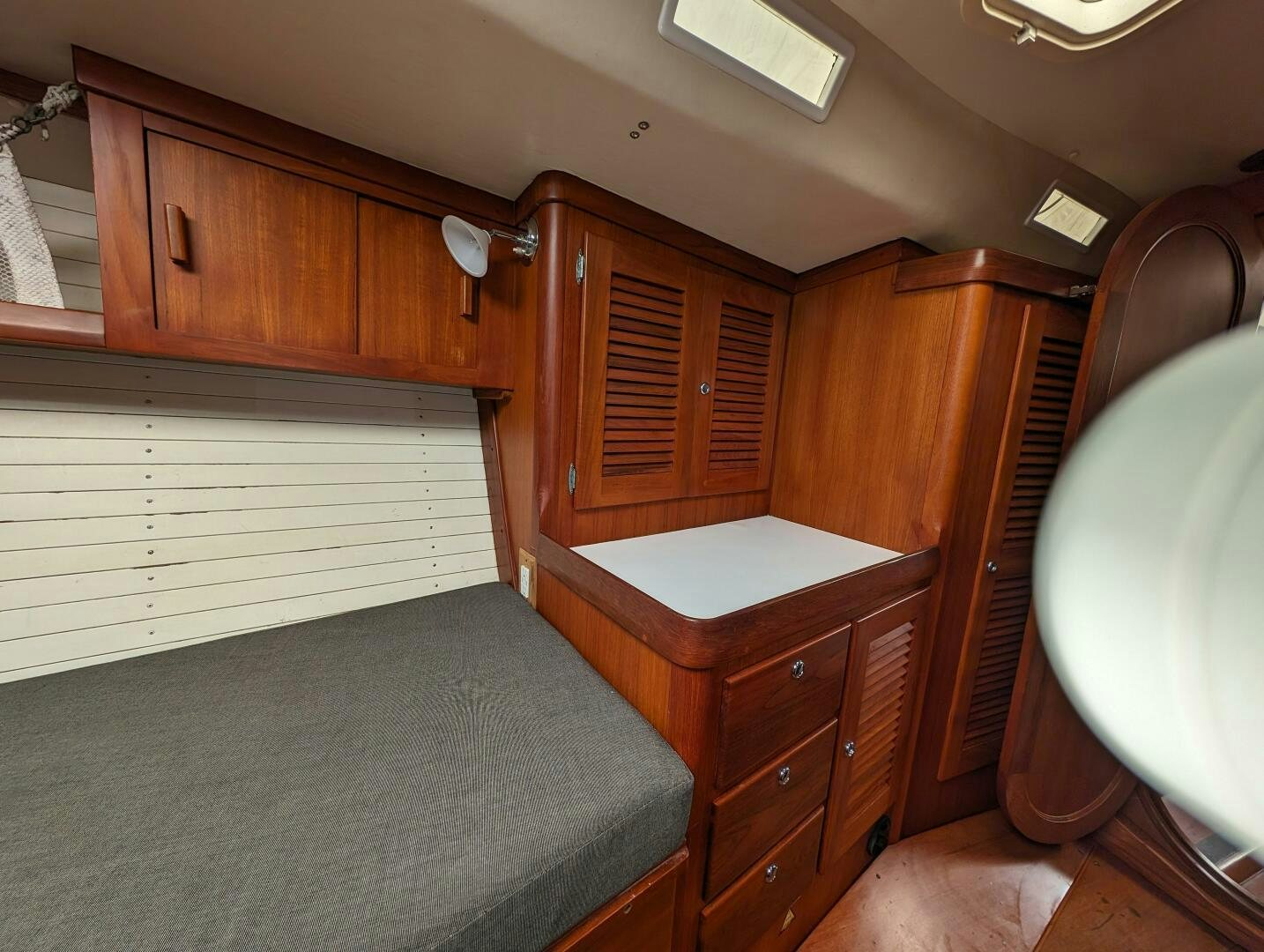 a room with wooden cabinets aboard MOJO Yacht for Sale