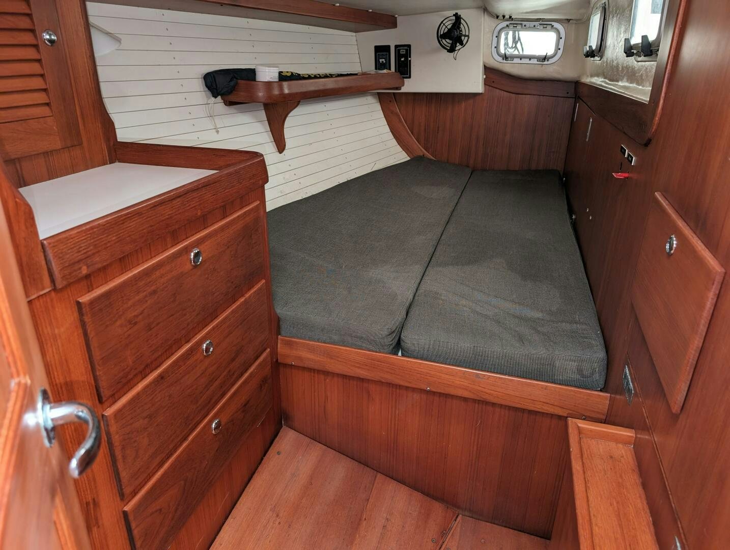 a room with wooden furniture aboard MOJO Yacht for Sale