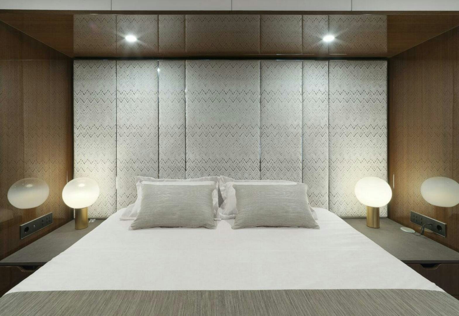 a bed with a white sheet aboard OV Yacht for Sale